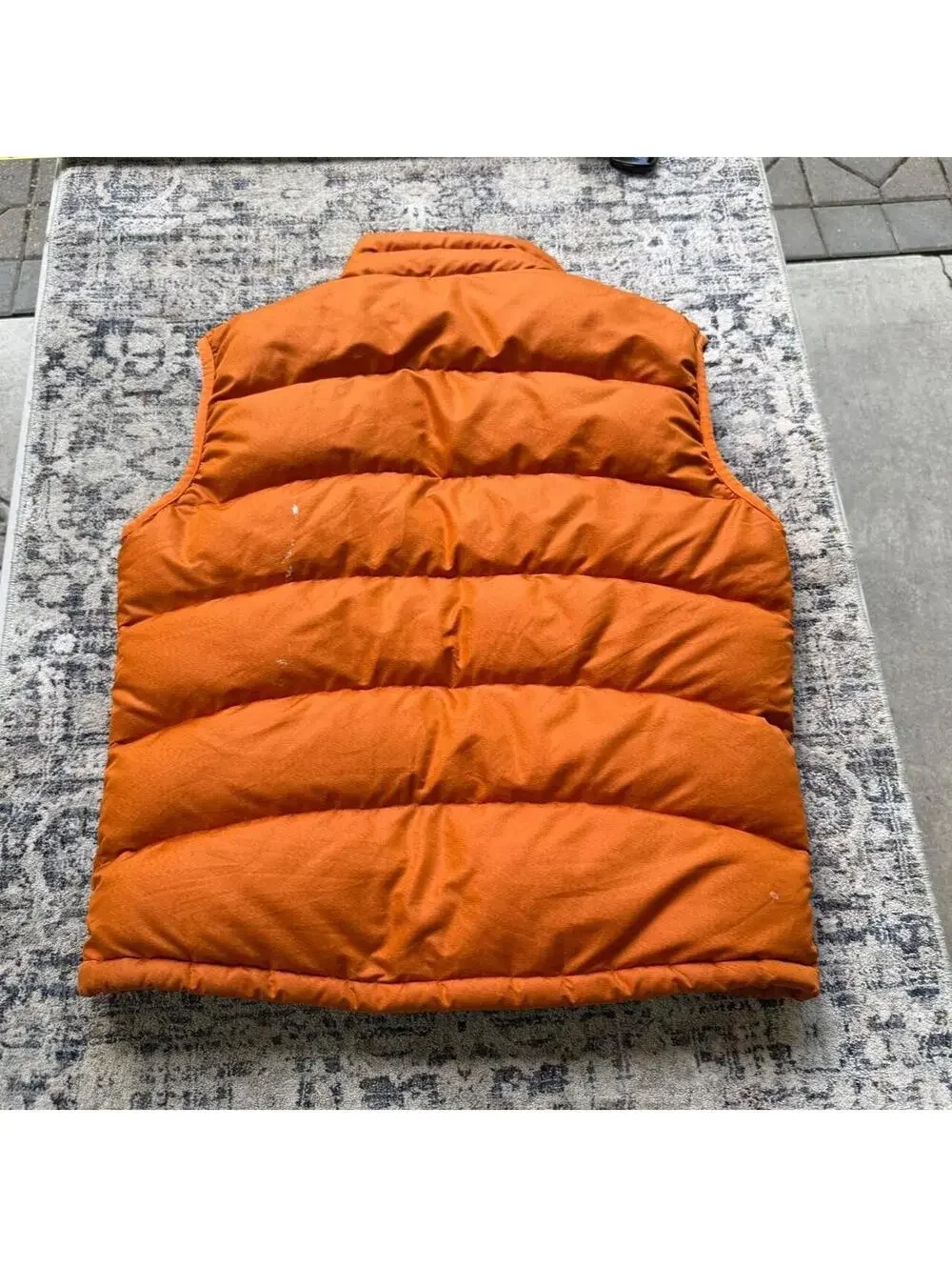 Vintage Patagonia orange puffer vest with stains